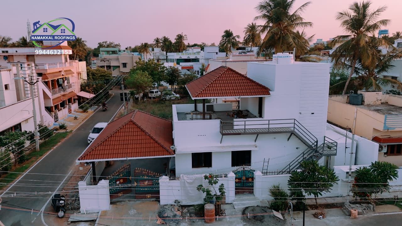Drone view of a home with a red tile roof in a Namakkal neighbourhood