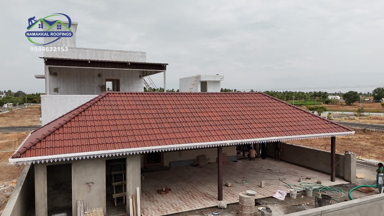 Clay tile roof being completed on a building under construction